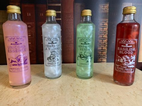 Our most popular and magical product! Get all 4 of our potions including Serpents Venom (Lemonade), Basilisk Blood (Mixed Fruits), Tears of A Wizard (Cream Soda), and Unicorn Essence (Fruit Twist).They come in 250ml bottles and the potions come to life with a magical shimmer when you use the potion spell.The potions are all sugar free and mix well with poisons such as gin, vodka and rum. Drinkable Potions, Magical Drinks, Shambles York, Sugar Free Drinks, Drink Cart, Carbonated Water, Pretty Drinks, Flavored Drinks, Cream Soda