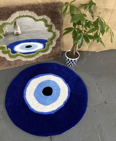 🔮 Ward off negative energy with our mesmerizing evil eye rug! Handcrafted with intricate detailing, this stunning piece combines rich symbolism with exquisite craftsmanship. Hang it on your wall or grace your floor, adding a touch of mystique and protection to your space. 👁️‍🗨️ #EvilEyeRug #WardOffNegativity #HandcraftedDecor #MysticVibes #HomeProtection #IntricateDesign Bratz Tufted Rug, Evil Eye Tufted Rug, Tufted Rug Wall Art, Uni House Decor, Tufted Rug Diy, Aesthetic Rugs Bedroom, Quirky Rug, Fall Swirl Nails, Evil Eye Room Decor