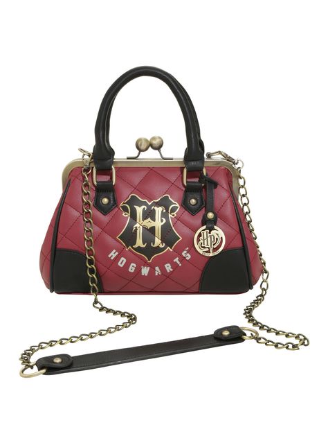 Maybe you shouldn't carry your wizarding needs in a cauldron when you're in the muggle world. It might raise some eyebrows. Keep it chic and undercover with this quilted burgundy satchel from Harry Potter with the Hogwarts crest and golden tone hardware.   9 1/2" x 7 1/2" x 3 1/2"  Polyurethane  Imported Harry Potter Handbags, Harry Potter Purse, Harry Potter Bag, Harry Potter Backpack, Harry Potter Quilt, Harry Potter Accessories, Harry Potter Merch, Harry Potter Merchandise, Bijoux Fil Aluminium