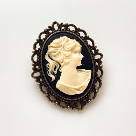 Cameo Brooch Vintage Lady Pin Brooch Bouquet Victorian Costume Cameo Jewelry -I make this brooch using a black and cream cameo and set it in an antique brass setting -Nickel free lead free alloy metal, resin cameo, C clasp closure -Measures 1 1/4" x 1 1/2" -Gift Boxed More of my Cameo Jewelry: https://www.etsy.com/shop/lydiasvintage?search_query=cameo More of my Brooches: https://www.etsy.com/shop/lydiasvintage?ref=seller-platform-mcnav§ion_id=6786664 Cameo Tattoo, Camphor Glass Jewelry, Bridesmaid Favors, Victorian Costume, Gothic Victorian, Cameo Jewelry, Vintage Lady, Brooch Bouquet, Victorian Lady