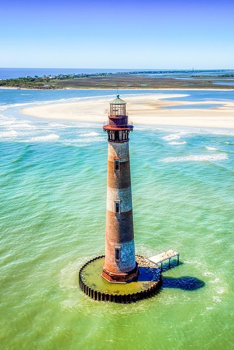 This small town on the edge of Charleston is full of charm and personality. One of the things that makes Folly Beach so unique is its proximity to the Morris Island Lighthouse. Although it's now abandoned, this lighthouse has a long and interesting history. If you're looking for a fun day trip from Charleston, be sure to check out the Morris Island Lighthouse! Note: The lighthouse is typically accessed by boat. 📸: 1778011 Abandoned Lighthouse Aesthetic, Morris Island Lighthouse, South Carolina Lighthouses, Beach Sculpture, East Coast Canada, Folly Beach South Carolina, Bodie Island Lighthouse, Folly Beach Sc, South Carolina Travel