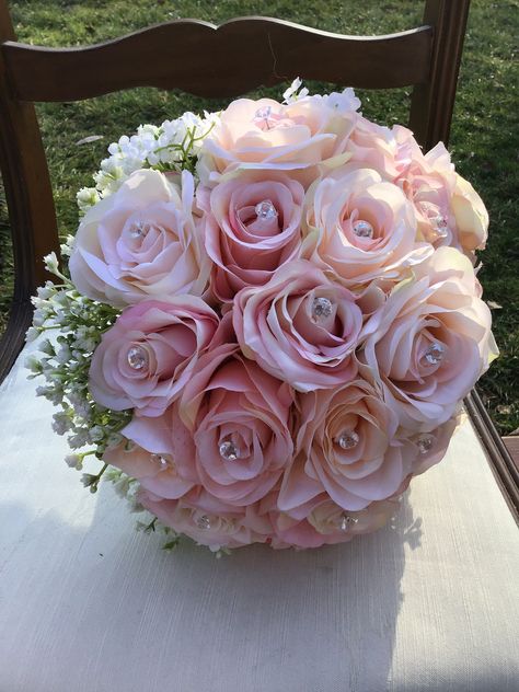 The Heather Collection This blushing bridal bouquet is simple and elegant. This beautiful silk bridal  bouquet features light pink blush roses and baby's breath.  A halo of baby's breath surrounds the roses at the bottom of the bouquet. Each rose is accented with a crystal like pin. The design is unique and classic.   The stems are partially wrapped in white satin ribbon with strips of diamondiqe wrap. This deluxe bouquet measures approximately 10 inches across and 12 inches tall.  Bridesmaid bouquets are light pink blush roses and baby's breath. Bridesmaid measures 8 inches across. Blush Pink Bouquet Quinceanera, Light Pink Bouquet Wedding, Light Pink Bouquet, Maroon Flowers, Quinceanera Bouquet, Bridal Wedding Bouquet, Silk Bridal Bouquet, Rose Bridal Bouquet, Wedding Bouquets Pink