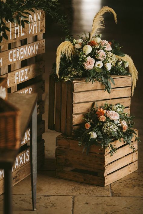 Rustic wooden crates topped with floral arrangements including pampas grass to create a beautiful backdrop for the order of the day sign. Barn Wedding Flowers, Rustic Barn Wedding Reception, Rustic Wedding Alter, Kim Wedding, Barn Wedding Ideas, Outdoor Wedding Backdrops, Wedding Reception Entrance, Karen Alexander, Reception Entrance