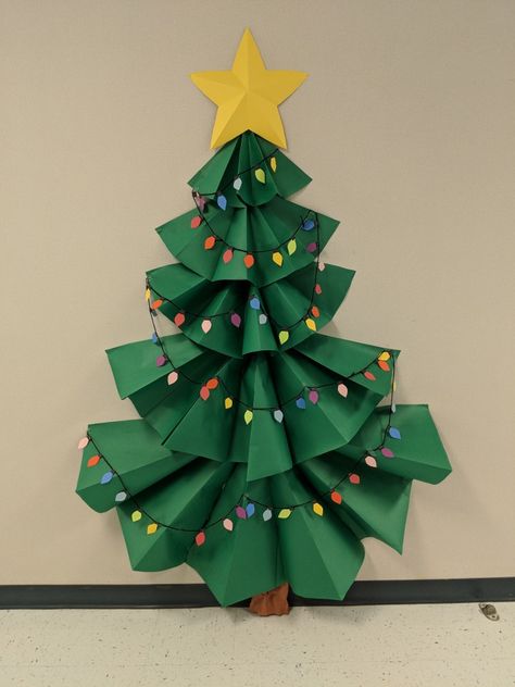 3-D Christmas tree bulletin board. Diy Christmas Tree Classroom, Classroom Paper Christmas Tree, Christmas Decoration Bulletin Board, Christmas Tree For Classroom Door, Paper Christmas Tree Door Decoration, Bulitin Board Ideas Christmas, Paper Christmas Tree Bulletin Board, Christmas Tree Ideas For Classroom, Office Christmas Bulletin Board