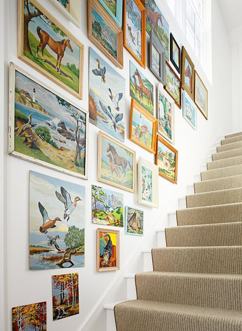 Eclectic nature paintings line this staircase to create a striking gallery wall. Mismatched frames keep the look rustic, but the similar paint-by-number style keeps things compatible. #cottagecore #homedecor #vintagedecor #vintageartwork #bhg Puzzle Wall Display, Puzzle Display Ideas, Types Of Painting Styles, Puzzle Wall Decor, Pretty Posters, Puzzle Wall, Butterfly Prints, Retro Painting, Colorful Outfits