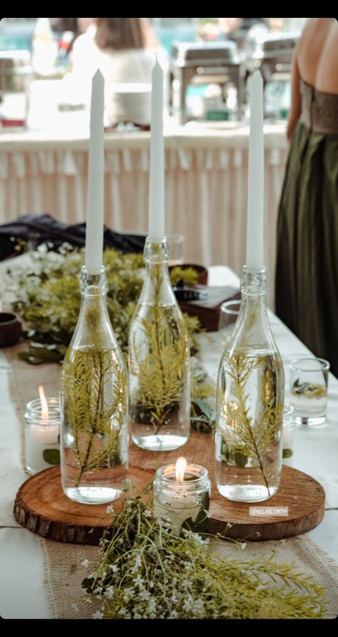 Candle In Wine Bottle Centerpiece, Wine Bottle With Candle Stick, Wine Bottle Display Ideas, Cocktail Workshop, Wedding Centerpeices, Bottles Decoration Wedding, Tapper Candles, Wine Bottle Candle Holder, Evergreen Candle