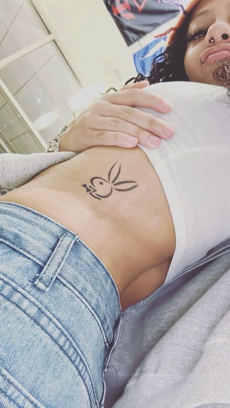 Rib And Stomach Tattoos For Women, Playgirl Tattoo, Playboy Bunny Tattoo Hip, Playboy Tattoo Design, Bad Girls Club Tattoo, Play Boy Tattoo, Playboy Bunny Tattoo Design, Panty Line Tattoo, Playboy Bunny Tattoo