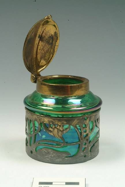 Inkwell, 1896-1910, Green glass ink well with art nouveau design in a copper alloy band around the rim. It has a hinged copper alloy lid. Mortimer Wheeler House (Ceramics and Glass store) Design Art Nouveau, Antique Inkwells, Glass Store, Ink Well, Vintage Writing, Art Nouveau Design, Dip Pen, Lost Art, Fountain Pen Ink