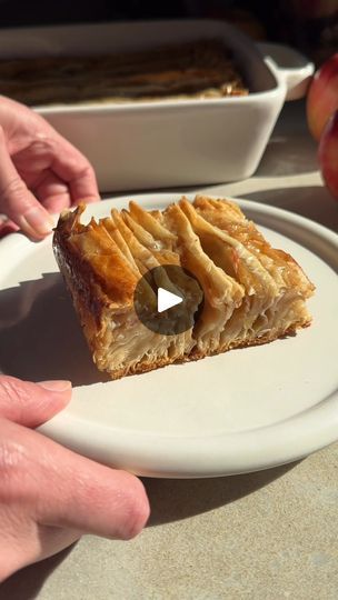 95K views · 1.2K reactions | Apple Phyllo Crinkle Cake | Apple Phyllo Crinkle Cake | By Crowded Kitchen | This apple Filo Crinkle Cake
tastes just as good as it looks and it's actually pretty easy
to make. Start by accordion folding several sheets of filo
dough and arrange them in a baking dish. Use a mandolin or
a knife to slice apples super thinly and then place the apple
slices between the filo folds and then bake for 10 minutes.
Next, drizzle with melted butter and then return to the
oven for another 10 minutes. The most important step is
making the custard. We use whole dairy milk for creaminess
and flavor and then add spices, eggs, and sugar. Pour over the
cake and return to the oven for another 35 minutes until it's
super crispy and golden brown. As soon as the cake comes out
of the Filo Crinkle, Crinkle Cake Phyllo, Phyllo Crinkle, Crinkle Cake, Filo Dough, Cake Apple, Crowded Kitchen, Cake Tasting, Crescent Rolls