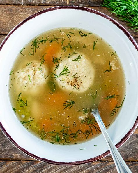 This Matzo Ball Soup is an exceptionally delicious Jewish dish made with matzah meal dumplings. One sip and and you will be hooked! #matzo #matzoballs #soup #recipe Chicken Matzo Ball Soup Recipe, Matzah Ball Soup Recipe, Matzo Ball Recipe, Matzo Ball Soup Recipe, Matzah Ball Soup, Kielbasa Soup, Kid Friendly Meals Dinner, Matzah Ball, Matzo Ball