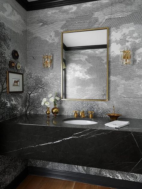 Beautifully dramatic black and gold powder room boasts a black marble floating sink vanity complemented with an antique brass vintage faucet mounted beneath a brass mirror hung from a wall clad in black and white wallpaper lit by brass and glass sconces. Floating Sink Vanity, Townhouse Bathroom, Black Powder Room, White Marble Sink, Powder Room Wallpaper, Powder Room Design, Marble Sinks, Black And White Marble, Bathroom Inspo