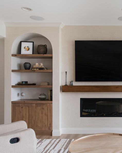 The perfect spot to display all your favorite things! 🤍 We’re obsessed with the charm these knotty alder arched built-ins bring to this basement living space. . . . Dealer: @two30nine Designer: @juliatwo30nine Chimney Built Ins, Arched Shelving Fireplace, Bookcase Next To Fireplace Freestanding, Arched Cabinets By Fireplace, Arched Entertainment Center, Arched Tv Built In, Arch Built In Shelves Fireplace, Fireplace With Arched Built Ins, Arched Built Ins Fireplace