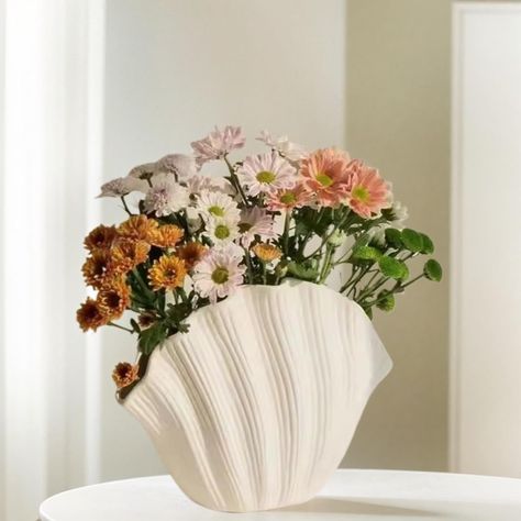 PRICES MAY VARY. Unique and Aesthetic Design: Immerse your home in an oceanic theme with our unique shell-shaped vase. Flaunting a classic ceramic finish and an aesthetically appealing Nordic , this vase is a addition to all décor including modern, farmhouse, offices, shops, restaurants, and cafes High Quality Craftsmanship: Our shell-shaped vase is a fine example of superior craftsmanship. Masterfully crafted from top-notch ceramic materials, this piece resonates with the exceptional skills and Centerpiece Table, Handmade Vase, Nordic Decor, Keramik Vase, Dried Floral, Home Decor Vases, Flower Accessories, Ceramic Flowers, Ceramic Decor