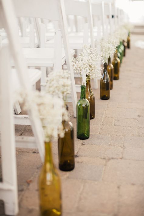 Wine Bottle Centerpiece For Wedding, Centerpiece With Wine Bottles, Simple Wedding Centerpieces Wine Bottles, Recycled Wine Bottles Wedding, Wedding Decor Wine Bottles, Wine Ceremony Wedding, Wine Bottle Vase Wedding, Wine Bottle Aisle Decor, Wine Bottle Aisle Decorations Wedding