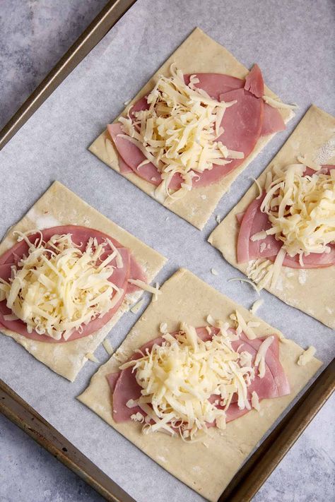 These ham and cheese puff pastries have a flaky puff pastry crust and gooey cheese interior sprinkled with a savory seasoning mix. The best part? You can eat them with your hands. No forks needed. Buttery pastry, salty ham, and melty cheese with a side of Dijon mustard? Talk about heavenly. Puffed Pastry Sandwiches, Ham And Cheese Danish, Cheese Pastry Puff, Easy Savory Puff Pastry Recipes, Puff Pastry Lunch Ideas, Ham And Cheese Puff Pastry Recipes, Ham And Cheese Puff Pastry Appetizers, Savoury Puff Pastry Recipes, Schar Puff Pastry Recipes