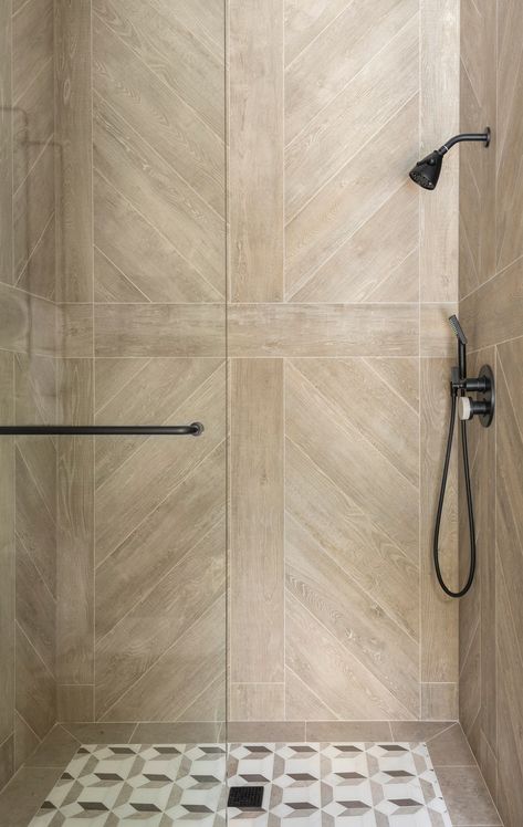 Lean into earthy elegance Bathroom Architectural Digest, Herringbone Shower Wall, Architectural Digest Bathroom, Accent Tile Bathroom, Master Shower Tile, Shower Accent Tile, Best Bedroom Paint Colors, Houston Interior Designers, Shower Tile Ideas