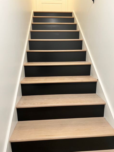 Split Level Downstairs Living Room Ideas, Black White And Wood Basement, White Room Black Ceiling, Two Tone Wood Stairs, Stair Backing Ideas, Stairs With Black Risers, Two Tone Stairs, Black Risers On Stairs, Redone Stairs