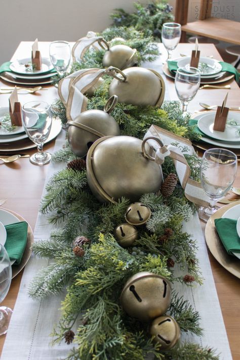 Oversized brass jingle bells atop greenery for simple table centerpiece #tablescape #vintage #christmascenterpiece #gold #greenery Jingle Bell Tablescape, Christmas Bells Centerpiece, Holiday Tablescapes Christmas Simple, Formal Christmas Party Table Centerpieces, Christmas Jingle Bell Centerpiece, Oversized Jingle Bells, Christmas Table Ornaments, Brass Christmas, Oversized Christmas Bells