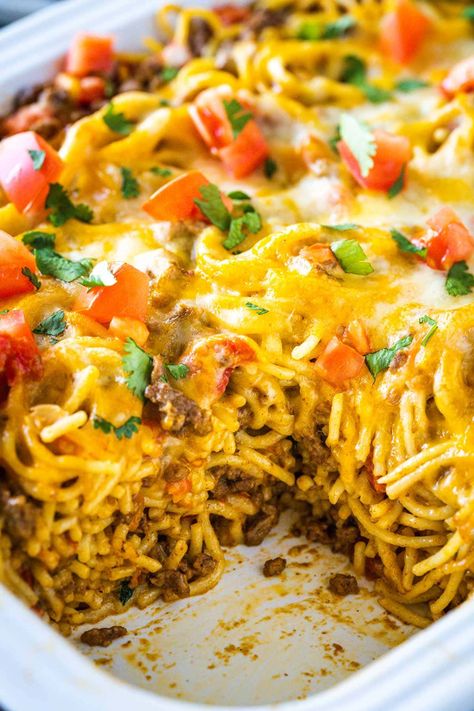 Try my Taco Spaghetti Bake tonight! It is a simple recipe made in a casserole dish, full of the best of Italian and Mexican food concepts- stirred into one cheesy meal! So Yummy! Baked Mexican Spaghetti Recipes, Baked Taco Spaghetti Recipe, Taco Spaghetti Bake With Velveeta, Easy Taco Spaghetti Bake, Taco Spaghetti Bake Ground Beef, Cheesy Taco Casserole Recipes, Cheesy Taco Spaghetti Bake, Nacho Spaghetti Casserole, Taco Spaghetti With Velveeta And Rotel