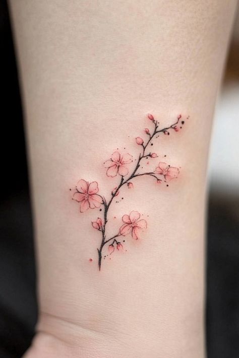 Cherry blossom tattoo on wrist. Small Japanese Cherry Blossom Tattoo, Tattoo Ideas Female Cherry Blossoms, Small Heart Flower Tattoo, Cherry Blossom Back Tattoo For Women, Fine Line Tattoo Cherry Blossom, Cherry Blossom Small Tattoo, Cherry Blossom Tattoo Collar Bone, Cherry Blossom Fine Line Tattoo, Unique Tiny Tattoos For Women