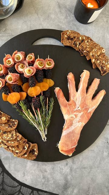 Ain’t Too Proud To Meg on Instagram: "#PromotionWithColumbusBrand SAVE this post & make a @columbusmeats SPOOKY HAND CHARCUTERIE for Halloween. @columbusmeats are my-go’s for serving up delicious, high-quality charcuterie and their Prosciutto and Italian Dry Salame are key to making this ghoulish spread. Full instructions ⬇️    INGREDIENTS  * 15.9 oz Gournay Garlic & Herb Cheese (or other soft cheese) * 3 oz @columbusmeats Prosciutto * 4 oz/22 slices @columbusmeats Italian Dry Salame * 3 oz/11 ciliegine * 1 oz/11 green olives stuffed with pimentos * 8 oz/20 blackberries * 4 oz/10 dried apricots * 5 sprigs rosemary * 4 oz crackers   SUPPLIES: plastic wrap & long toothpicks/skewers   INSTRUCTIONS: ⬇️   FOR THE HAND: 1. Line a bowl with plastic wrap and combine 10.6 ounces of herb cheese and Cheese Skewers, Garlic Herb Cheese, Halloween Cheese, Recipe With Cheese, Witch Fingers, Creepy Food, Spooky Halloween Treats, Herb Cheese, Olive Relish