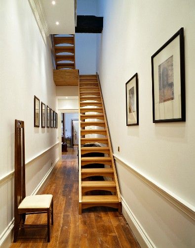 Art Nouveau-period chair and open wooden staircase in narrow hall Loft Conversion Stairs, Wooden Staircase, Narrow Staircase, White Leather Dining Chairs, Wayfair Living Room Chairs, Outdoor Lounge Chair Cushions, Open Staircase, Interior Design Images, Unique Photos