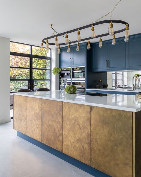 This kitchen combines classic shaker-style cabinets with a contemporary antique brass island, all wrapped in a stunning ultramarine blue theme, creating a perfect blend of tradition and modernity. #KitchenDesign #ShakerStyle #KitchenGoals https://www.solakitchens.com/ultramarine-and-brass/ Brass Island, Hanging Light Bulbs, Shaker Style Cabinets, Ultramarine Blue, Blue Theme, Room Black, Kitchen Plans, Blue Kitchens, Utility Room