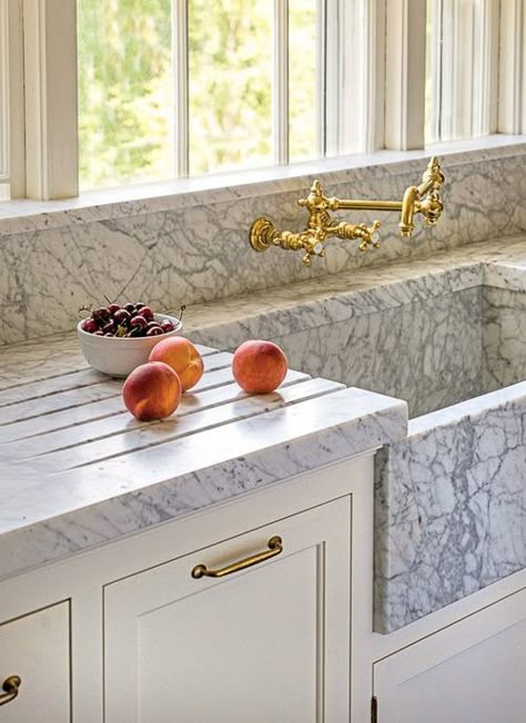 Grooves are cut into the marble surrounding this marble sink. The grooves are a nice feature, regardless of what counter material is selected, as they help to eliminate the splashes and puddles that accumulate around the sink. Kitchen Marble Ideas. Top Kitchen Trends, Curved Kitchen, Kitchen Cabinet Trends, Painted Kitchen Cabinets Colors, Green Kitchen Cabinets, New Kitchen Designs, Marble Sinks, Sink Design, Kitchen Farmhouse