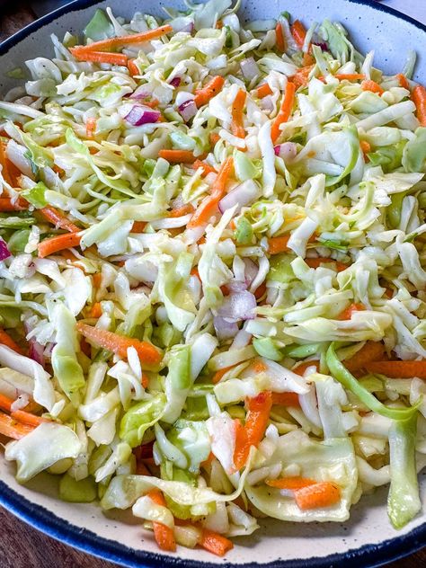 This vibrant Vinegar Coleslaw Without Mayo recipe offers a zesty alternative to traditional creamy coleslaw, perfect for those seeking a lighter and tangier option. With a crisp and crunchy mix of shredded cabbage and carrots tossed in a flavorful vinegar-based dressing, this dish is bursting with freshness. Whether served as a refreshing side at summer barbecues or as an accompaniment to your favorite sandwiches and tacos, this is sure to become a staple. Coslaw Recipes Vinegar, Coleslaw Recipe Without Mayo, Easy Vinegar Coleslaw Recipe, Creamy Vinegar Coleslaw Recipe, Slaw Dressing Recipe Vinegar, Coleslaw Vinegar Based, Shredded Cabbage Recipes Healthy, Vinager Coleslaw Recipe Vinegar, Coleslaw Dressing Vinegar