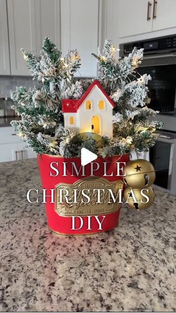 Dodie Vanhooser on Instagram: "Simple Christmas DIY: Effortless Holiday Charm

Get ready to create the simplest holiday arrangement that will have your home brimming with joy! 🎄✨ 
I’m starting with a classic red and gold bucket as the base, popping in two mini flocked Christmas trees, a touch of magic with some jingle bells and the cutest red and white light-up farmhouse. Wrap the trees in twinkle lights, and there you have it—an easy, timeless display that says holiday cheer in every way.
I use mine on a console, but just as cute on a tabletop, or end table.  This DIY is so simple anyone can do it! 

Comment LINK and I will send you a DM with links to everything I used for this arrangement!  Or click the blue link in my bio 😉🎄Enjoy!! 

Live Beautifully✨Love Deeply✨Be Grateful

#SimpleC Christmas Buckets Diy, Simple Christmas Diy, Christmas Buckets, Christmas Decorating Hacks, Decorating Hacks, Holiday Arrangement, Flocked Christmas Trees, Live Beautifully, Easy Christmas Diy