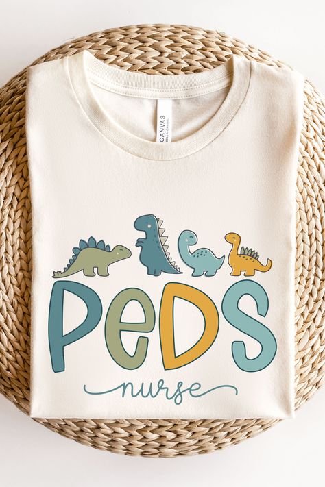 Showcase your dedication as a PEDS Nurse with our dino-themed nurse shirt! Designed for comfort and style, this shirt is perfect for Pediatric Nurses, PICU Nurses, and anyone in the PEDS field. Make a statement while providing exceptional care to your young patients. Neonatal Nurse Practitioner, Picu Nurse, Mother Baby Nurse, Nurse Midwife, Neonatal Nurse, Pediatric Occupational Therapy, Neonatal Intensive Care Unit, Nurse Shirts, Pediatric Nurse