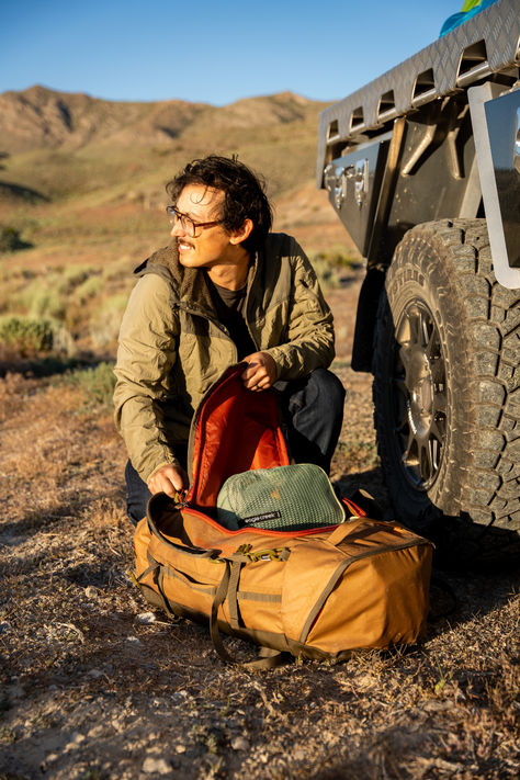 Man unpacking a duffel bag Bush Plane, Rolling Bag, Lightweight Luggage, Eagle Creek, Baggage Claim, Travel Towel, Backpacking Packing, Travel Duffel, The Eagle