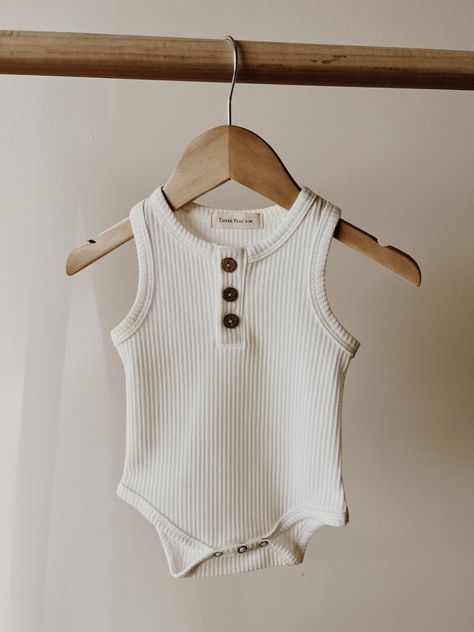 They are great for every day wear, layering, or dressing up. This soft and cozy wardrobe staple will surely be a favorite. Cozy Wardrobe, Classic Baby Clothes, Newborn Clothing, Bodysuit White, Baby Boutique Clothing, Bodysuit Designs, Waffle Fabric, Baby Fits, Tank Bodysuit