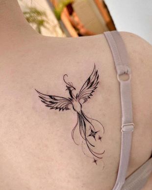 Rising Phoenix Tattoo Designs: Symbolic Ideas for Men and Feminine Back, Arm, and Hip Tattoo Ideas Phoenix Design, Phoenix Tattoo Wrist, Phoenix Tattoo Shoulder, Phoenix Hip Tattoo, Rising Phoenix Tattoo Feminine, Simple Phoenix Tattoo, Womens Back Tattoos, Feminine Phoenix Tattoo, Small Phoenix Tattoo