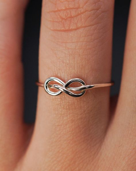 The Infinity Knot Ring is really cute and easy to wear on a daily basis! The infinity knot detail adds a bit of extra interest to a classic hammered stacking ring. This ring is a great alternative to a stacking ring and it looks beautiful combined with other stacking sets. This ring makes a lovely alternative engagement ring, as well as a promise or friendship ring! This listing is for ONE SINGLE RING. Each ring is made from solid STERLING SILVER. Choose from THIN (.7mm) or THICK (1mm) metal. NO Couples Promise Rings, Infinity Knot Ring, Promise Rings Simple, Space Rings, Friendship Ring, 18th Century Clothing, Infinity Knot, Pretty Jewelry Necklaces, Sterling Silver Promise Rings