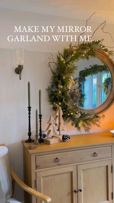 Mirror And Wreath Decor, Mirror Wreath Christmas, Circle Mirror Christmas Garland, Mantle Mirror Christmas Decor, Christmas Decor Ideas With Mirrors, Wreath Around Mirror, Anthro Mirror Christmas, Christmas Wreath Mirror Ideas, Round Mirror With Garland