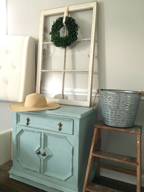 Master Bedroom, Nightstand after, distressed, rustoleum chalk paint, serenity blue, diy, tufted white bed, chair rail molding, farmhouse decor, antique vintage window, boxwood wreath Sewing Cabinet Makeover, Rustoleum Chalk Paint, Chair Rail Molding, Blue Diy, Blue Chalk Paint, Arm Chair Styles, Bedroom Nightstand, Vintage Window, Sewing Cabinet