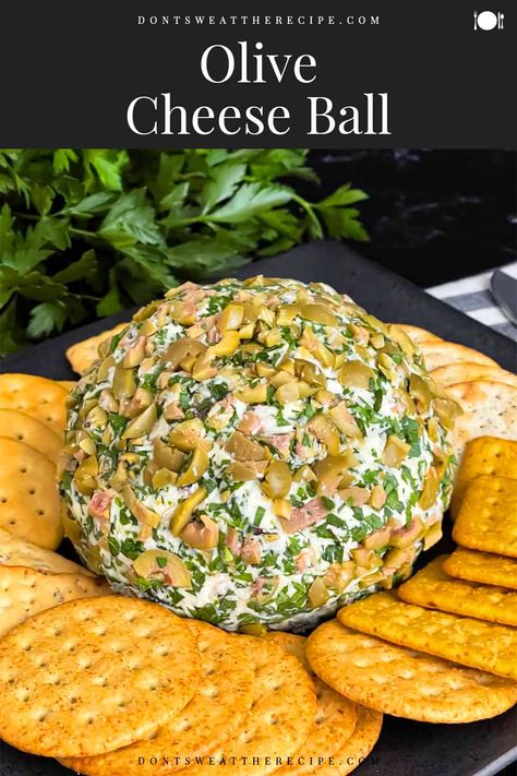 This Olive Cheese Ball recipe made with 3 different cheeses and the salty goodness of green olives, and kalamata olives is perfect for parties and gatherings all year. It's sure to please! Mediterranean Cheese Ball, Olive Platter Appetizers, Olive Balls Appetizers, Olive And Pickle Tray, Olive Cheese Ball Recipes, Green Olive Appetizer Ideas, Olive Party Theme, Olive Cheese Balls, Green Olive Cheese Ball