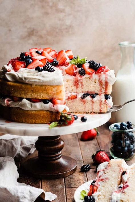 Berry Cake is made with two fluffy layers of moist vanilla cake sandwiched with freshly whipped cream, and topped with sweet, juicy berries. This elegant cake is easy to assemble and tastes like a berry shortcake in cake form! | bluebowlrecipes.com Summer Berry Cake, Berry Cake Recipe, 30th Cake, Fluffy Layers, Berry Shortcake, Moist Vanilla Cake, Cake Form, Elegant Cake, Cake Maker