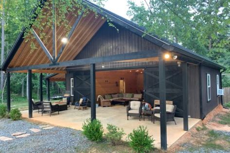 Metal Building With Carport, Pole Barn Garage Interior, Pole Barn Colors Scheme, Party Barn Interior, Black Metal Building, Black Cabins, Barn Shop Ideas, Barn Pool House, Barn Makeover