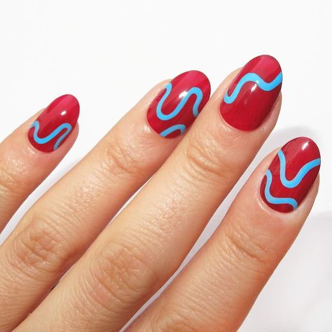 Red Nails: Blue Squiggles. A red base with light blue wavy lines. Click through for 30 red nail ideas. #rednails #nailideas #nailart IG: @nataliepnails Red Nail Design, Ladybug Nails, Red Ombre Nails, Red And Gold Nails, Mens Nails, Watermelon Nails, Blue Nail Art, Red Nail Designs, Blue Nail Designs