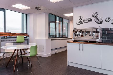 An alternative view of the Liferay office kitchen design with wooden circular table and green chairs across from the main kitchen coffee station Break Out Space, Break Out Area, Barista Style, Out Space, Barista Fashion, Office Designs, Meeting Rooms, Company Culture, The Staff