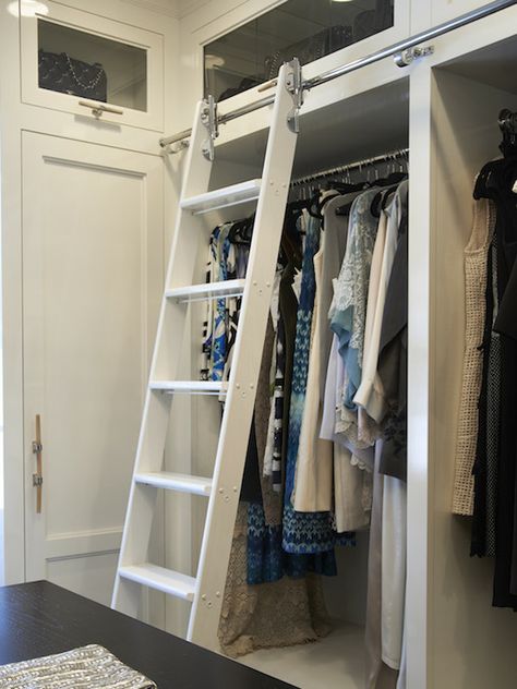 Luxurious walk-in closet with white built-ins accented with natural horn cabinet pulls alongside ... Ladder In Closet, Displaying Purses, Ladder Closet, White Closets, Closet Ladder, Closet Library, Ladder Library, Luxurious Walk In Closet, Placard Design