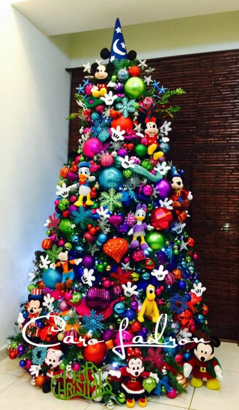 As Christmas approaches, children begin insisting on going to Disneyland to spend the holidays. But it isn’t always possible to take a leave and visit the gorgeous place. But there’s one thing you can always go, transform your house into Disneyland. Yes, we’re talking about Disney Christmas... Mickey Mouse Tree, Natal Do Mickey Mouse, Colored Christmas Tree, Mickey Mouse Christmas Tree, Disney Tree, Disney Xmas, Amazing Christmas Trees, Disney Christmas Decorations, Disney Christmas Tree