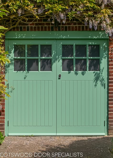 A pair of classic Art deco 1930s garage doors with vertical tongue and groove style boarding. The doors are side hinged and have been equipped with traditional door stays to hold each door open. Six square obscured glass panels in each door permit lightflow into the garage. Painted in a fresh mint green and fitted with polished chrome door furniture, these 1930s garage doors and matching 1930s front door create a charming first impression of this London home. Garage Doors Uk, Garage Door Hinges, Georgian Doors, Wooden Garage Doors, Garage Door Styles, Contemporary Doors, Garage Door Design, Wooden Garage, Garage Shed