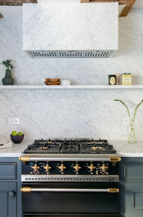 Fabulous kitchen features a marble kitchen hood suspended over a marble floating shelf lining a marble slab backsplash above a black and gold French stove, La Cornue CornuFé 1908 Stove flanked by dark gray cabinets adorned with matching dark gray knobs. Lacanche Range, New York Townhouse, Brooklyn House, Marble Shelf, Kitchen Hood, Marble Kitchen, Kitchen Hoods, Big Design, Kitchen Marble