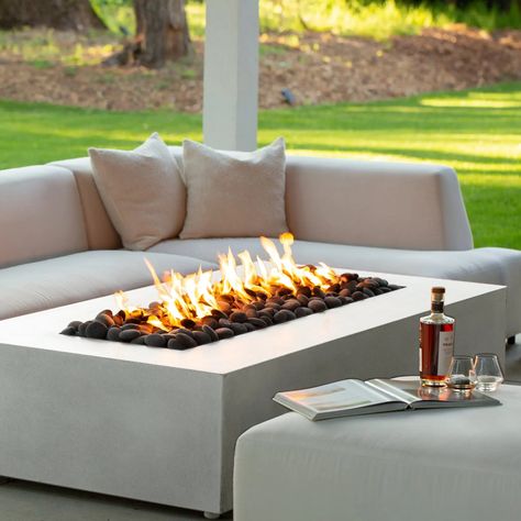 Make your outdoor gatherings cozier with the Starfire Designs Gravity 72" x 38" Rectangle Concrete Gas Fire Pit as it livens up your backyard or patio with luxurious flames. Boasting of a stainless steel burner rated at 175,000 BTUs, you and your loved ones will be basking in warmth in almost no time. Effortlessly integrate the Gravity into your residential or commercial space to enjoy a snug atmosphere during the coldest of nights. Made from a unique concrete and fine glass blend known as glass Contemporary Fire Pit, Natural Gas Fire Pit, Modern Fire Pit, Glass Fire Pit, Concrete Fire Pits, Gas Fire Pit, Propane Fire Pit, Gas Fire, Fire Features