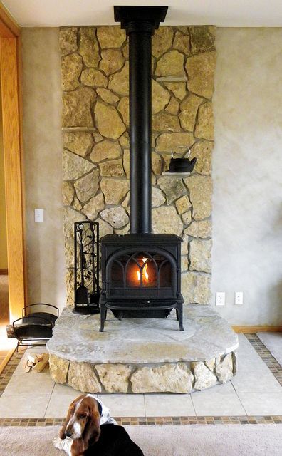 This wood stove uses Buechel Stone's Glacier River Rock for the back and risers, and Fond du Lac Steppers for the hearth pad area. Want to see more? Check out www.buechelstone.com/shoppingcart/products/Glacier-River-... Tiled Hearth, Wood Burning Stove Corner, Corner Wood Stove, Wood Stove Surround, Stove Hearth, Hearth Pad, Wood Stove Wall, Wood Stove Hearth, Lake House Living Room