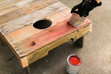 Using a palm sander and a fine grit paper, sand the rough spots down so that the bags will slide a bit when they hit the boards (Image 14). Dust off boards after sanding. To add vintage color, dip the tip of a dry brush into latex paint, barely getting paint on the bristles. Using this dry brush method, lightly sweep color onto the boards (Image 15). To add a white stripe, protect the sides using craft paper secured with painters tape. Lightly sweep white spray paint down the vertical center ... Diy Cornhole Boards From Pallets, Backyard Games Kids, Diy Cornhole, Diy Cornhole Boards, Corn Hole Diy, Decorative Lanterns, Cornhole Game, White Spray Paint, Pallet Decor