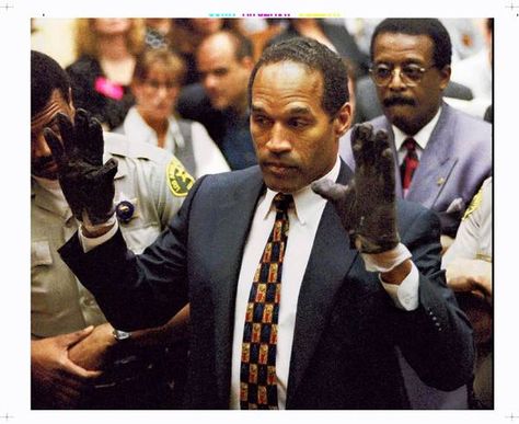 O.J. Simpson displays the gloves to the jury. "If it doesn't fit, you must acquit," defense attorney Johnnie L. Cochran Jr. told jurors O J Simpson, Oj Simpson, Robert Kardashian, Reality Shows, Bill Clinton, Mike Tyson, Reality Tv Shows, Ex Wives, كرة القدم